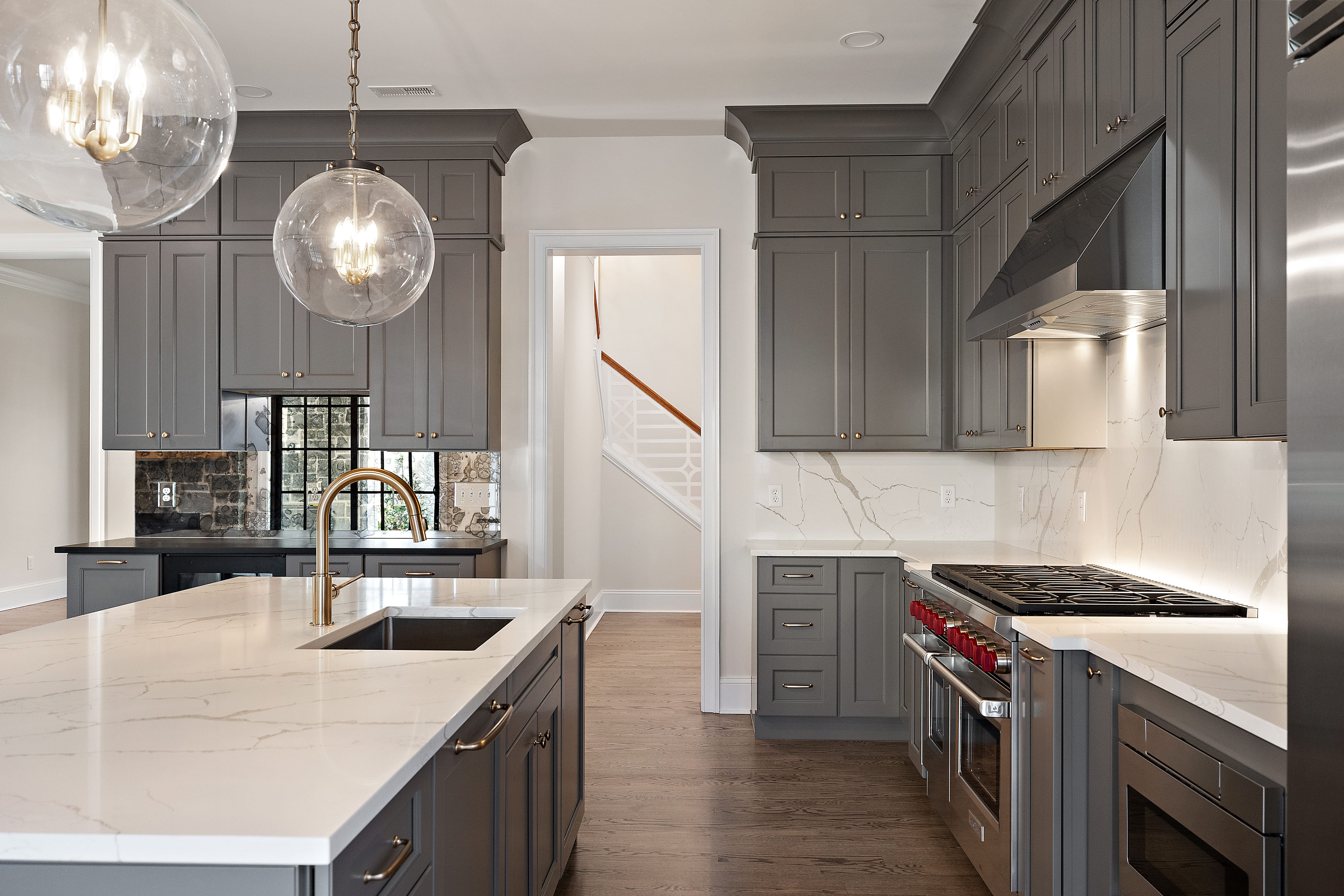 Renovated kitchen with glass globe pendants