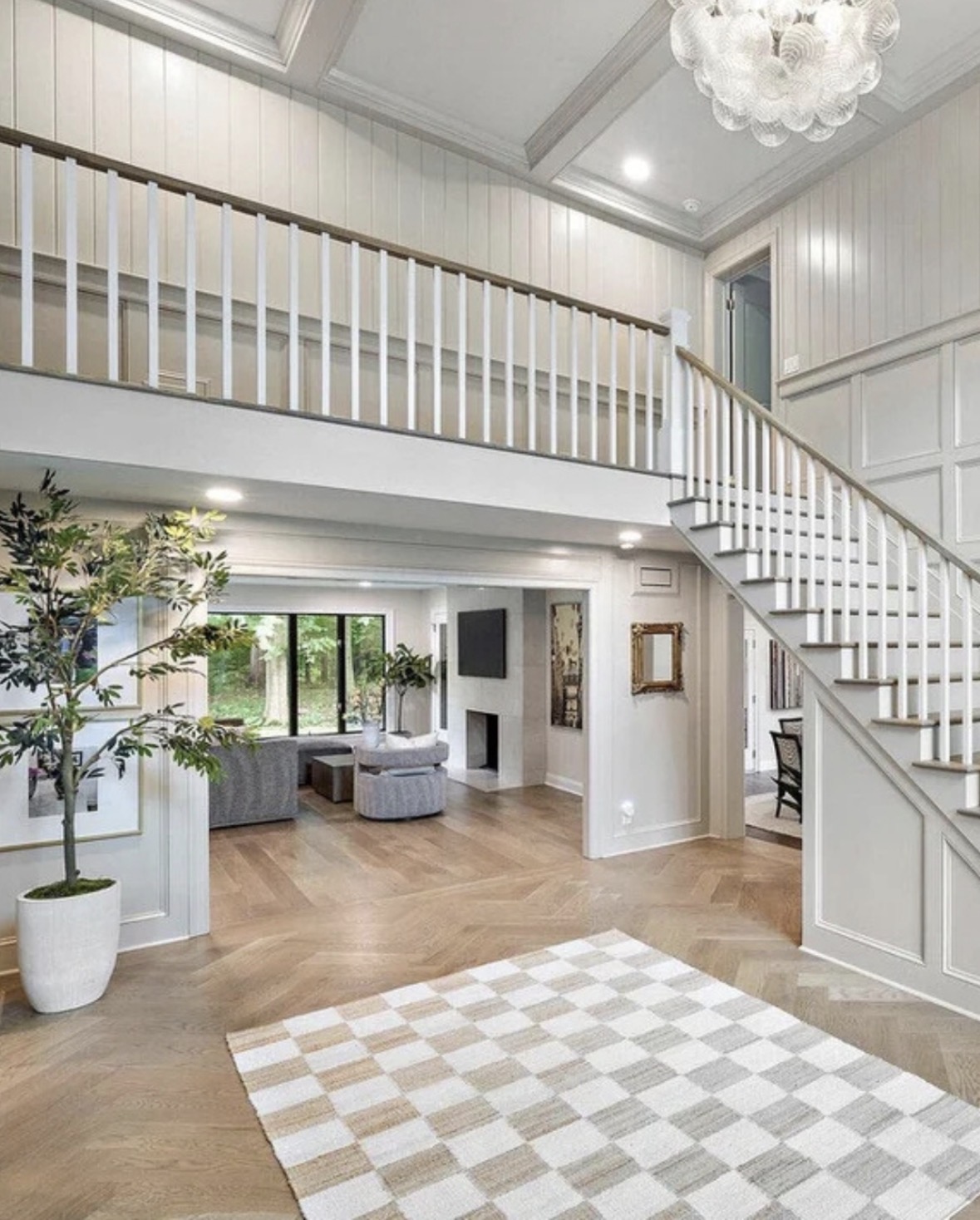 Foyer staircase with statement chandelier
