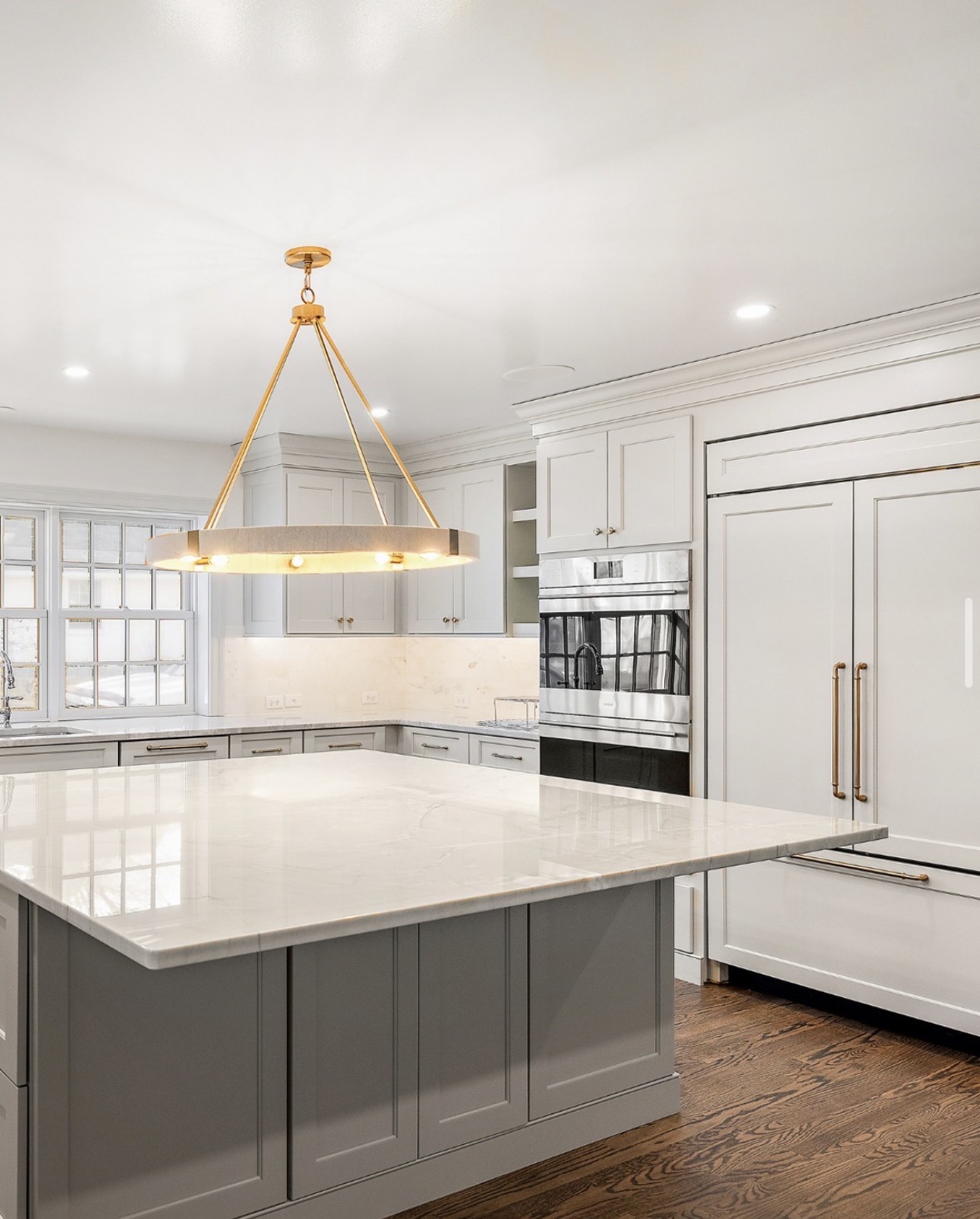 White kitchen with brass ring chandelier